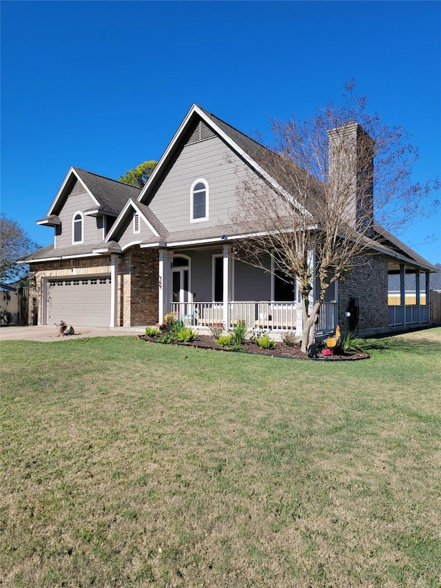 view of front of house with a front yard, a porch, and a garage