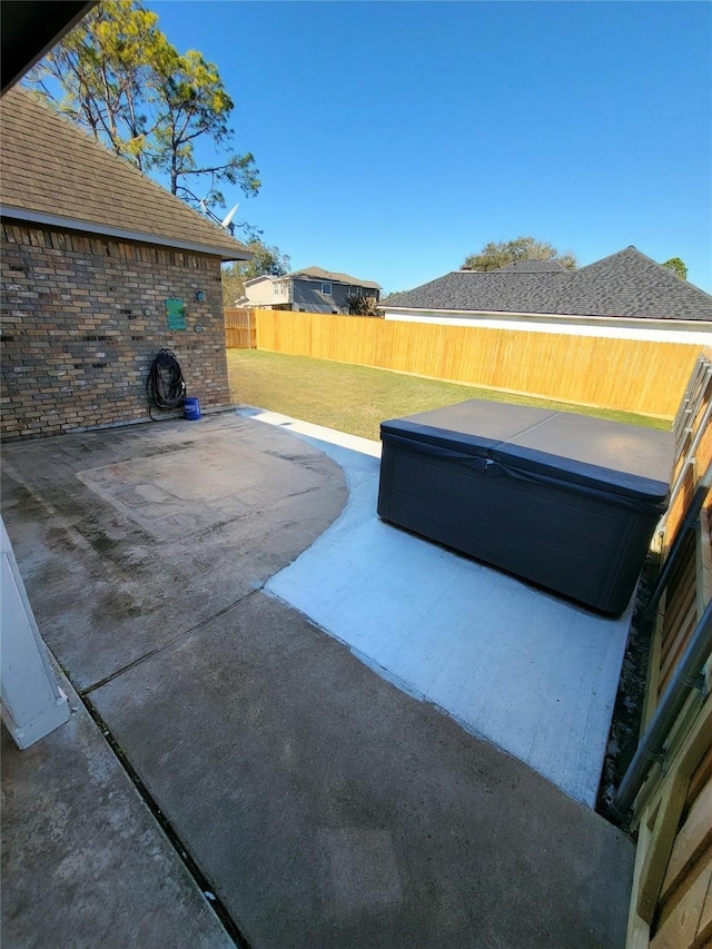 view of patio / terrace with a hot tub and a fenced backyard