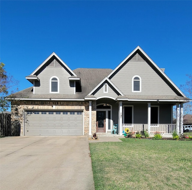 view of front facade featuring covered porch, a garage, and a front lawn