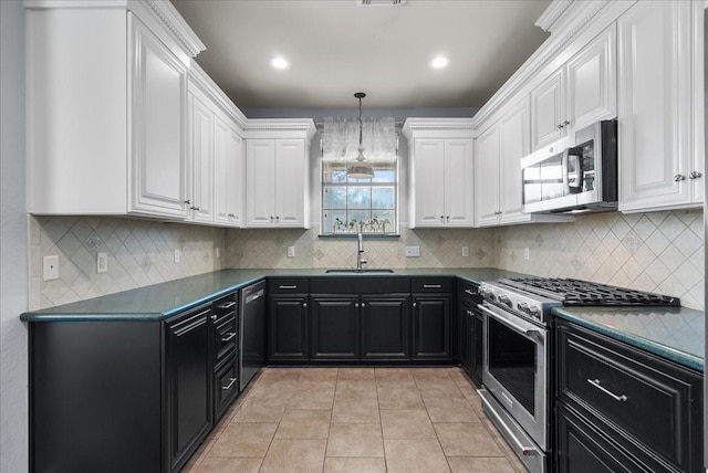 kitchen featuring appliances with stainless steel finishes, dark countertops, white cabinets, and dark cabinets