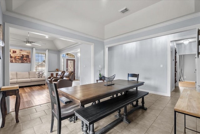 dining area featuring ornamental molding, lofted ceiling, visible vents, and light tile patterned floors