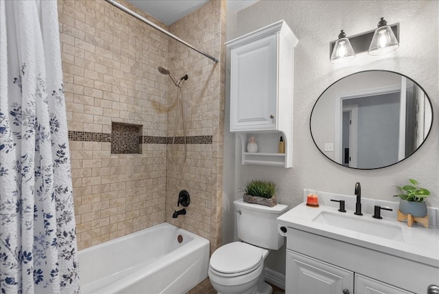 bathroom featuring toilet, a textured wall, shower / bath combination with curtain, and vanity