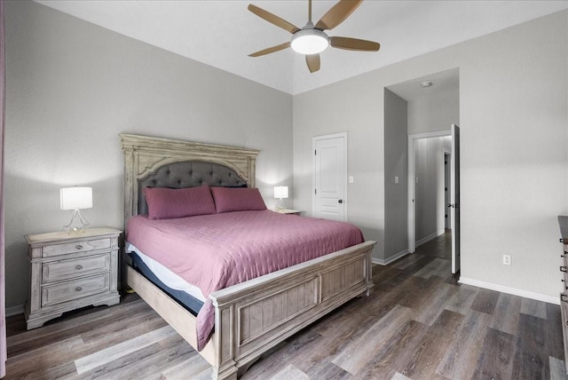 bedroom with ceiling fan, dark wood finished floors, and baseboards