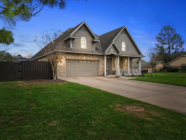 view of front of house with a garage, a lawn, a porch, and concrete driveway