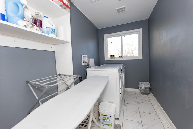 clothes washing area with washer and clothes dryer