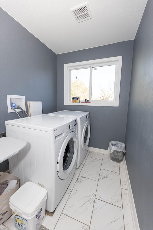 clothes washing area with washing machine and clothes dryer