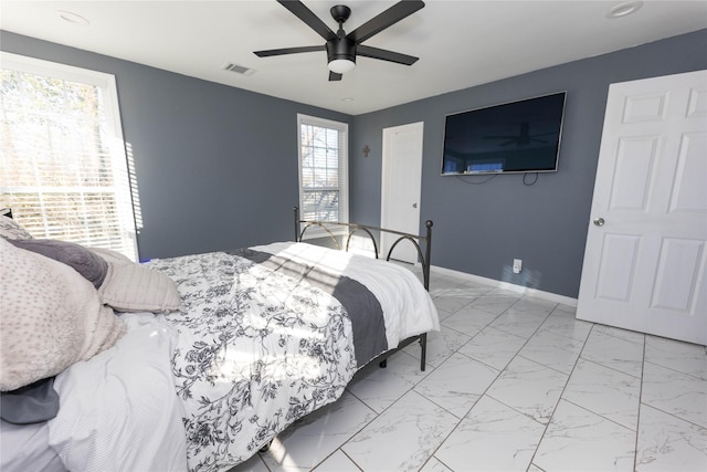 bedroom featuring ceiling fan and multiple windows