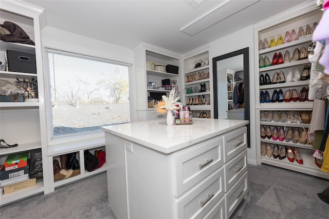 walk in closet featuring dark carpet