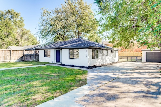 single story home with a garage, an outdoor structure, and a front yard