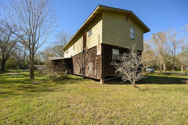 view of side of home with a yard