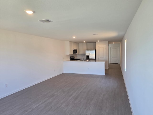 unfurnished living room with dark hardwood / wood-style flooring