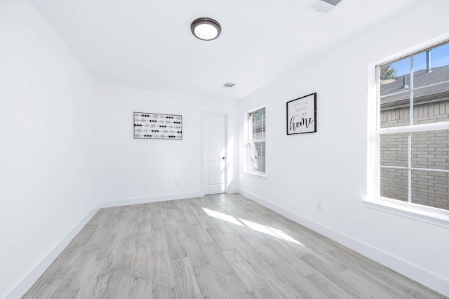 empty room featuring light hardwood / wood-style flooring and plenty of natural light