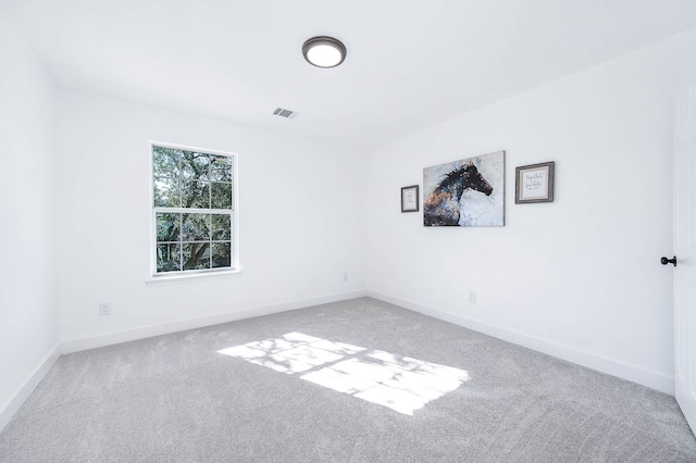 unfurnished room with light carpet