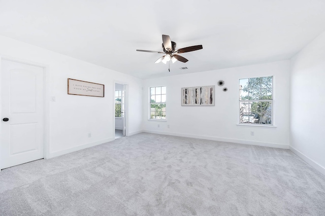 carpeted spare room with ceiling fan