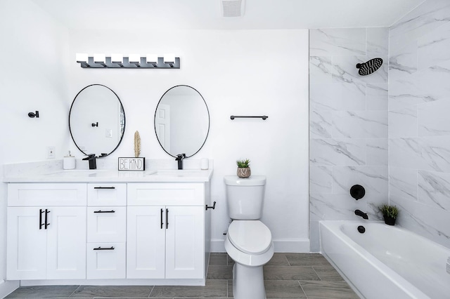 full bathroom featuring vanity, toilet, and tiled shower / bath