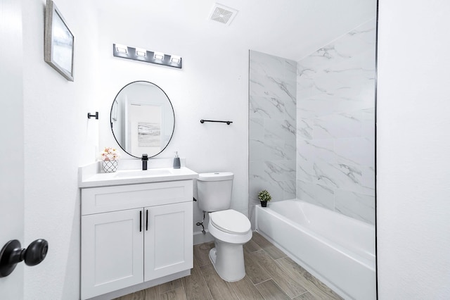 full bathroom featuring vanity, toilet, and tiled shower / bath