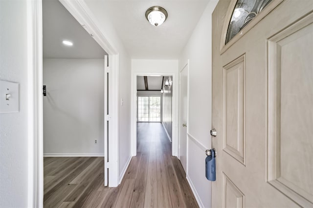 hallway with wood-type flooring