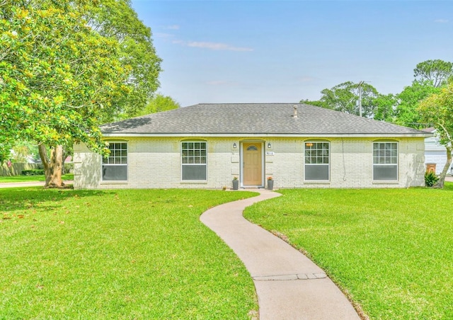 ranch-style home featuring a front yard