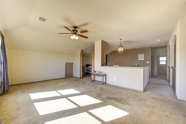 unfurnished living room featuring ceiling fan, light colored carpet, and vaulted ceiling