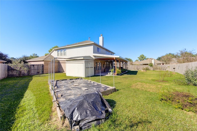 rear view of house with a yard