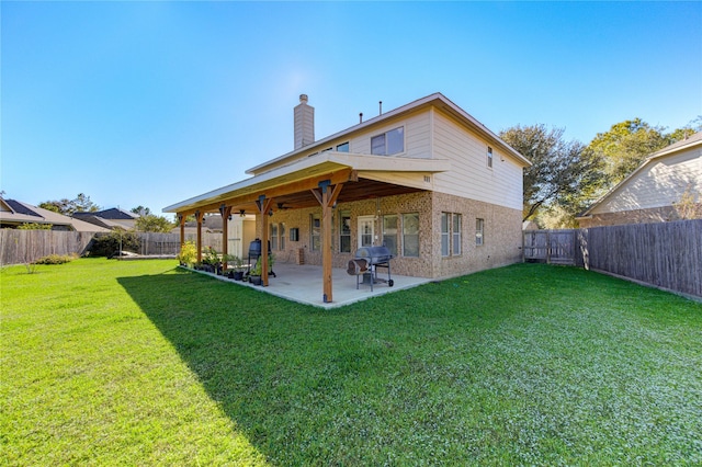 back of property with a lawn and a patio