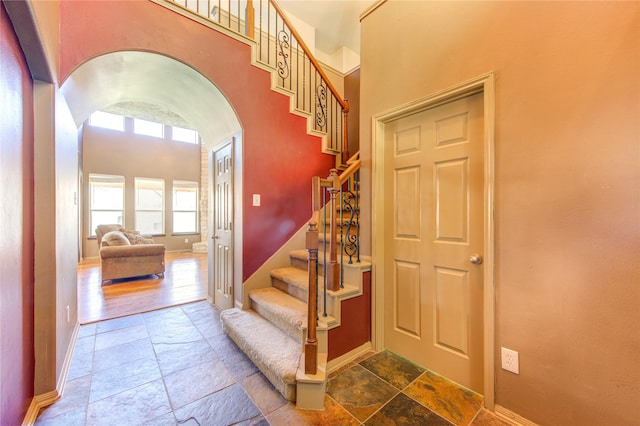 staircase with a towering ceiling