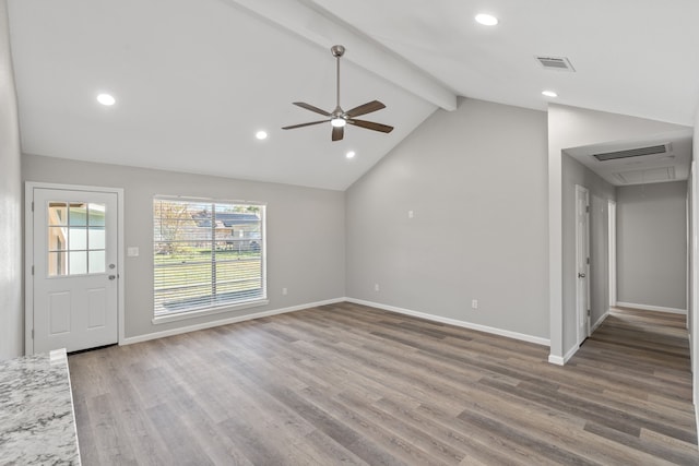 unfurnished living room featuring ceiling fan, lofted ceiling with beams, and wood-type flooring