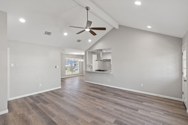 unfurnished living room featuring ceiling fan, lofted ceiling with beams, and wood-type flooring