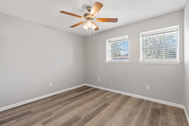 spare room with ceiling fan and hardwood / wood-style flooring