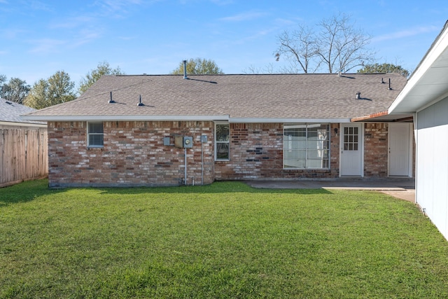 back of house featuring a lawn