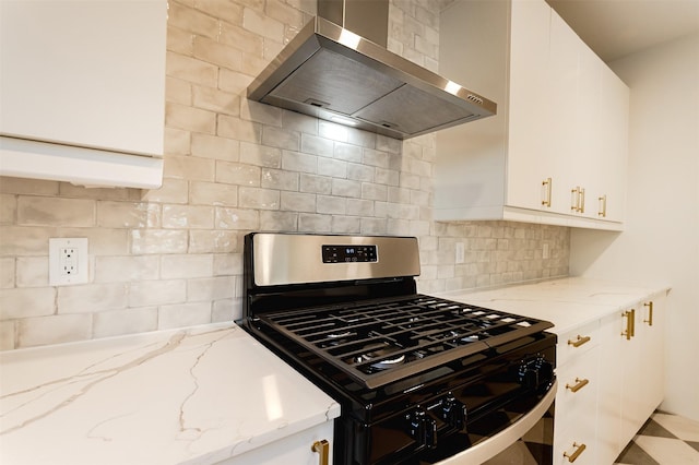 kitchen featuring white cabinets, stainless steel range with gas cooktop, wall chimney exhaust hood, decorative backsplash, and light stone countertops