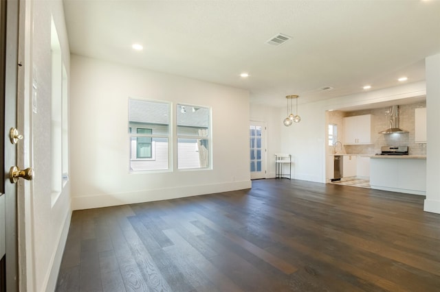 unfurnished living room with dark wood-type flooring