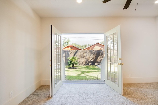 doorway with carpet flooring, ceiling fan, and french doors