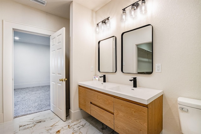 bathroom featuring vanity and toilet