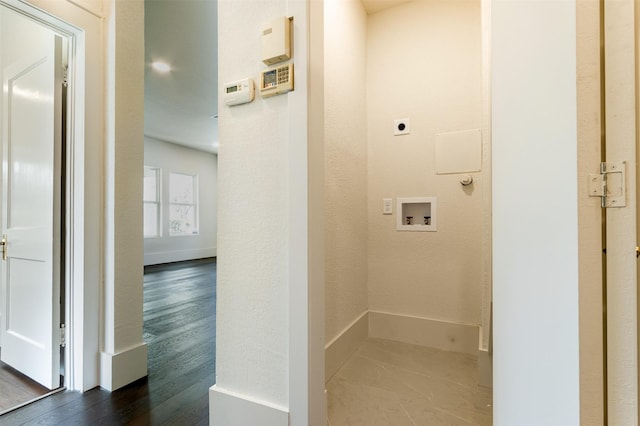 clothes washing area featuring hookup for an electric dryer, washer hookup, and hardwood / wood-style floors