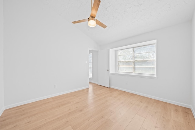 empty room featuring a textured ceiling, ceiling fan, vaulted ceiling, and light hardwood / wood-style flooring