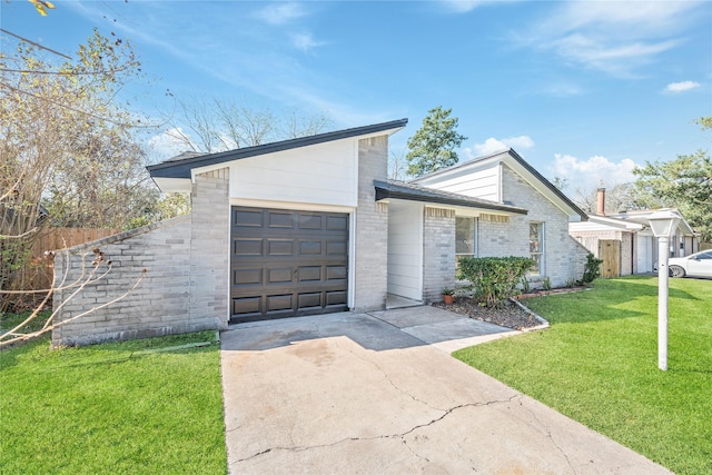 view of front of home with a front yard and a garage