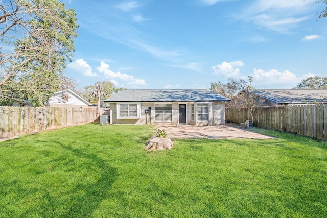 rear view of house featuring a patio and a lawn