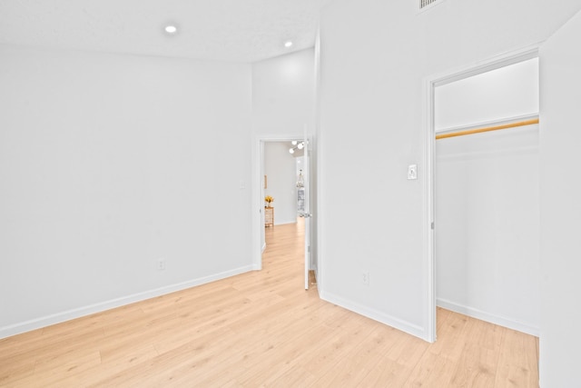 unfurnished bedroom featuring light wood-type flooring and a closet