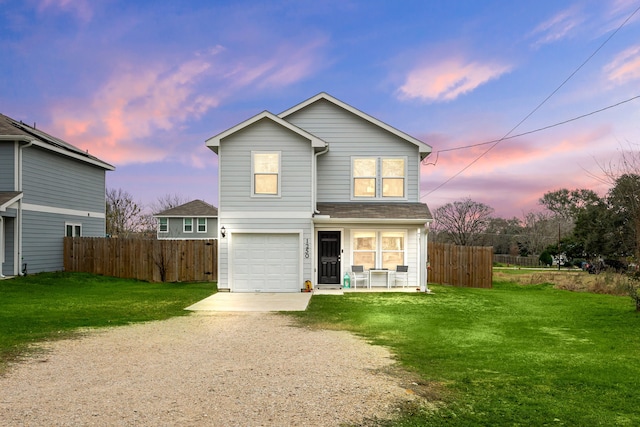 front facade with a garage and a yard