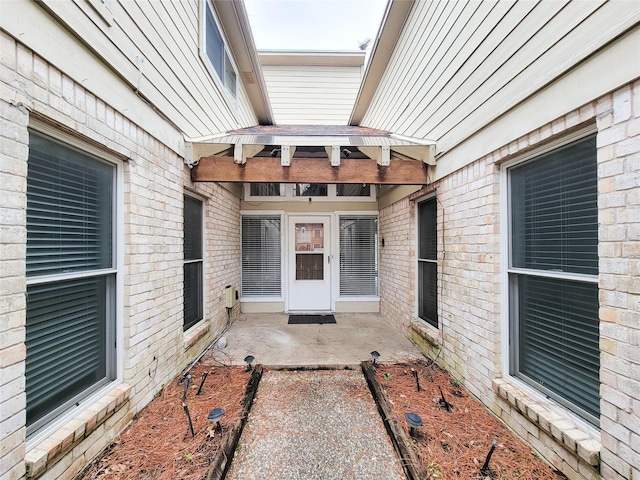 property entrance featuring a patio