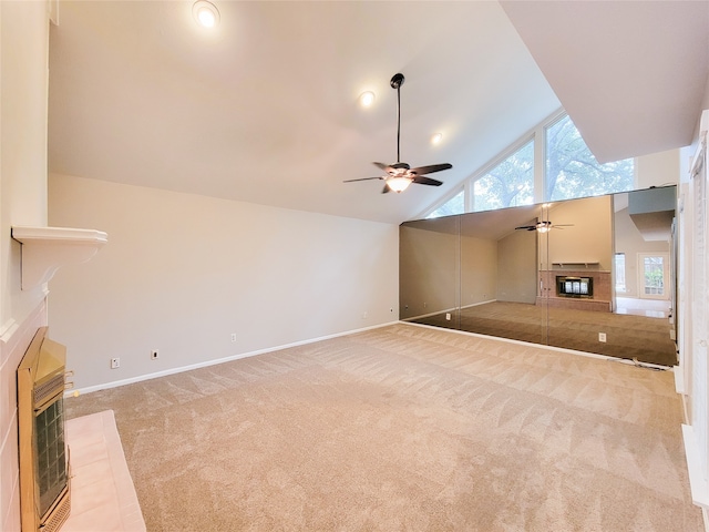 unfurnished living room with ceiling fan, light colored carpet, high vaulted ceiling, and heating unit