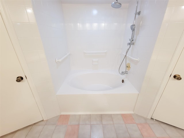 bathroom featuring tile patterned floors and tiled shower / bath