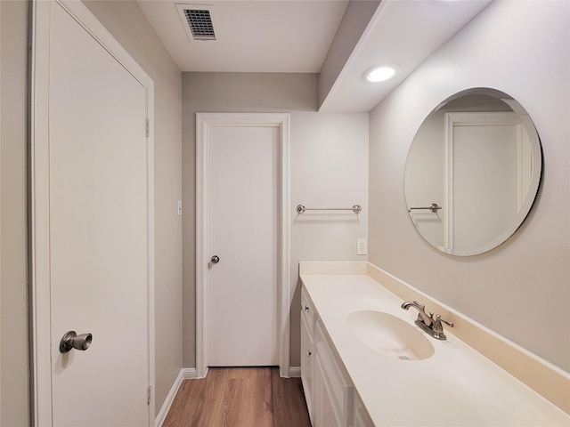 bathroom with hardwood / wood-style floors and vanity