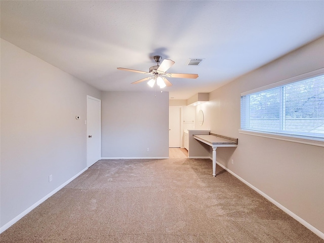 carpeted spare room with ceiling fan