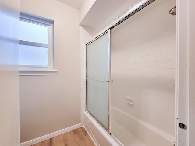 bathroom featuring shower / bath combination with glass door and hardwood / wood-style flooring