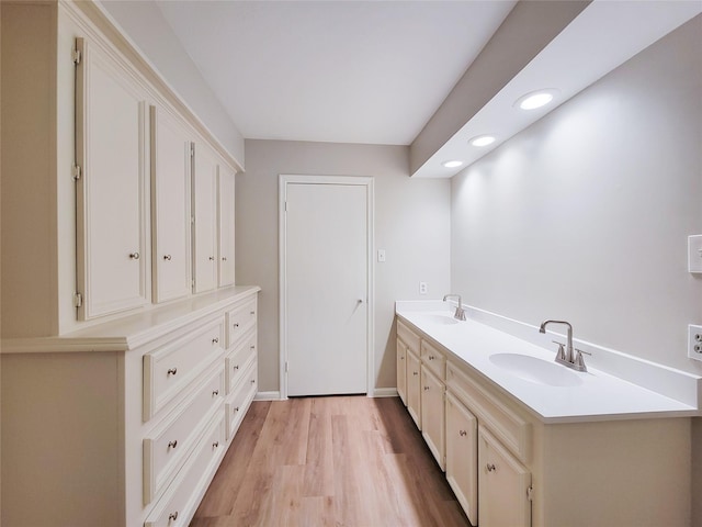 bathroom with vanity and hardwood / wood-style flooring