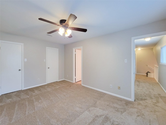 empty room with light carpet and ceiling fan