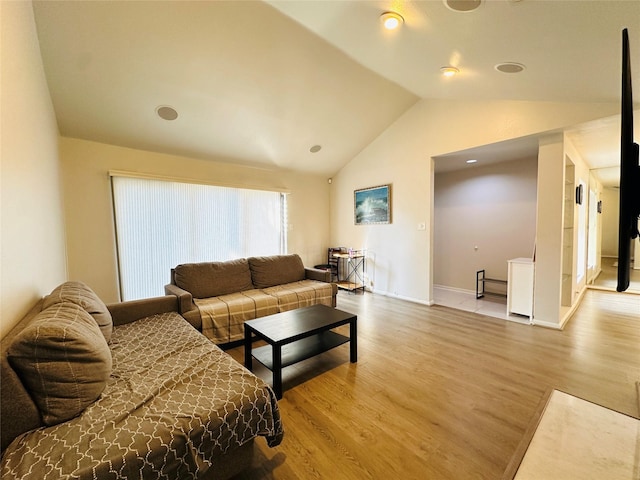 living room with wood-type flooring and lofted ceiling