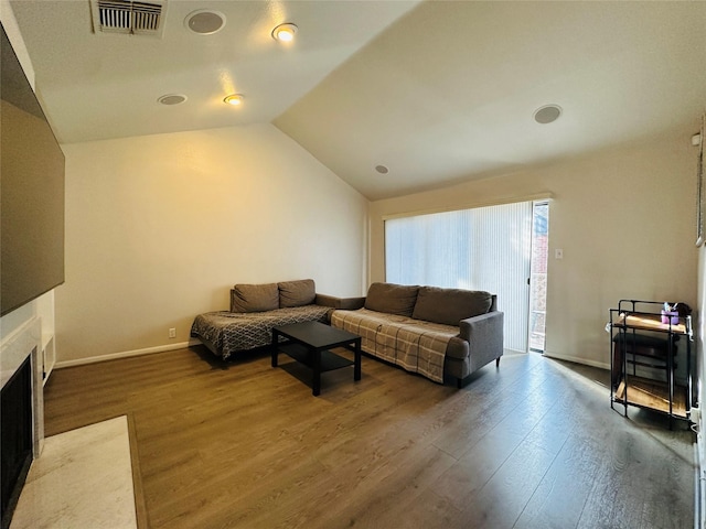 living room with hardwood / wood-style floors and lofted ceiling